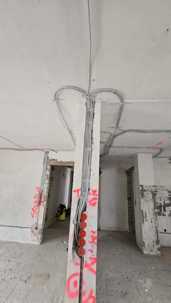 Verlegte Leitungen an Decke und Pfeiler mit Unterputzdosen während der Rohinstallation